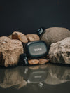 BOYA microphone and receiver on rocks with a dark background