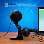 Microphone with 3.5mm headphone jack on a desk with laptop and headphones, against a blue background.